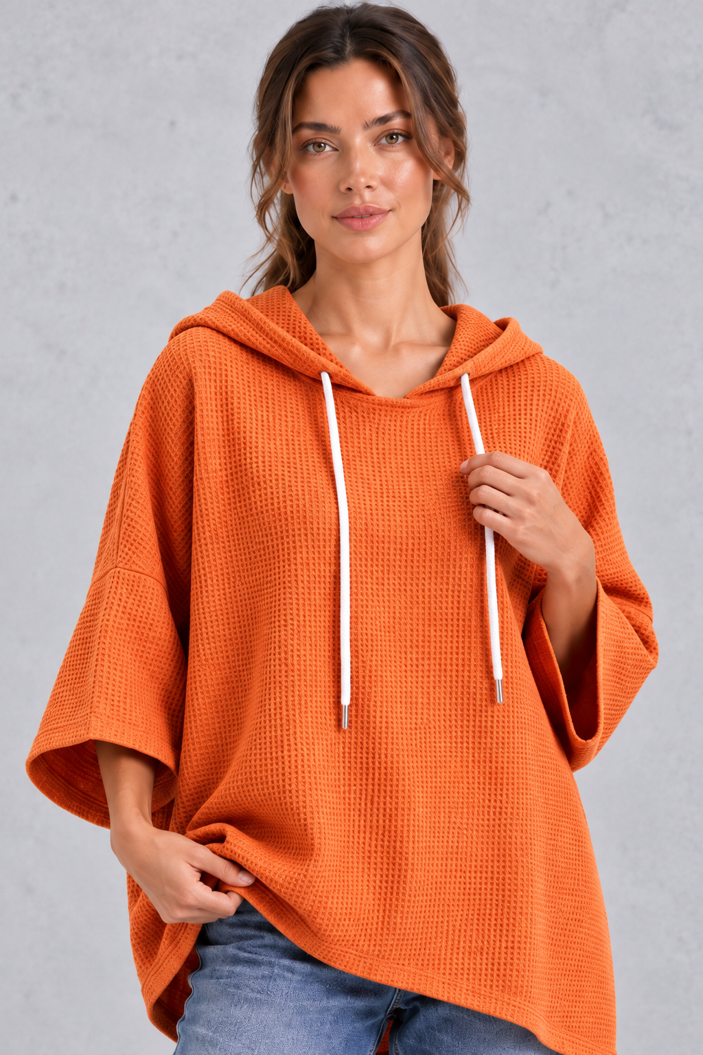 Women's plus size orange waffle knit hoodie – close-up of drawstring hood and waffle texture