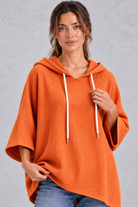 Women's plus size orange waffle knit hoodie – close-up of drawstring hood and waffle texture