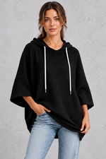 Women's plus size black waffle knit oversized hoodie with white drawstrings and wide sleeves – front view