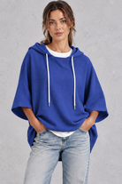 Women's plus size blue waffle knit oversized hoodie with drawstring hood and wide sleeves – front view