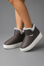Women's knee-high winter boots with a smooth PU upper, soft plush lining, slip-on design, lightweight wedge heel and non-slip rubber sole, providing warm, comfortable everyday wear for autumn and winter.