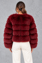 Women’s plush cropped faux fur winter jacket with a rounded neckline, long sleeves and a soft voluminous silhouette.