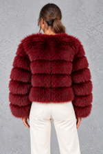 Women’s plush cropped faux fur winter jacket with a rounded neckline, long sleeves and a soft voluminous silhouette.