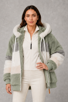 Women’s plush hooded winter coat with soft faux fur panels, a relaxed silhouette and rib-knit cuffs for cosy cold-weather layering.