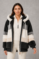 Women’s plush hooded winter coat with soft faux fur panels, a relaxed silhouette and rib-knit cuffs for cosy cold-weather layering.