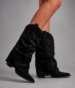 Women’s pointed toe knee high boots with a low chunky heel and relaxed Western-inspired shaft in a neutral shade.
