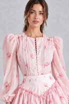 Women’s printed ruffle mini dress with long lantern sleeves, structured shoulders, cascading ruffle detailing and a defined waist.