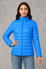 Women’s quilted puffer jacket with horizontal padding, high stand collar, zip-front fastening and a lightweight streamlined silhouette.
