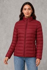 Women’s quilted puffer jacket with horizontal padding, high stand collar, zip-front fastening and a lightweight streamlined silhouette.