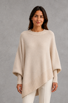 Women’s ribbed high neck knit jumper with long sleeves and a relaxed, softly draped silhouette for autumn and winter wear.
