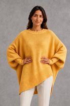 Women’s ribbed high neck knit jumper with long sleeves and a relaxed, softly draped silhouette for autumn and winter wear.