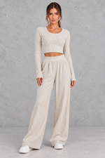 Women’s ribbed knit two-piece set with a fitted long-sleeve cropped top, scoop neckline and matching wide leg trousers.