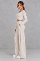 Women’s ribbed knit two-piece set with a fitted long-sleeve cropped top, scoop neckline and matching wide leg trousers.
