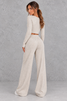 Women’s ribbed knit two-piece set with a fitted long-sleeve cropped top, scoop neckline and matching wide leg trousers.