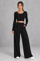 Women’s ribbed knit two-piece set with a fitted long-sleeve cropped top, scoop neckline and matching wide leg trousers.