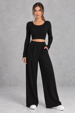Women’s ribbed knit two-piece set with a fitted long-sleeve cropped top, scoop neckline and matching wide leg trousers.