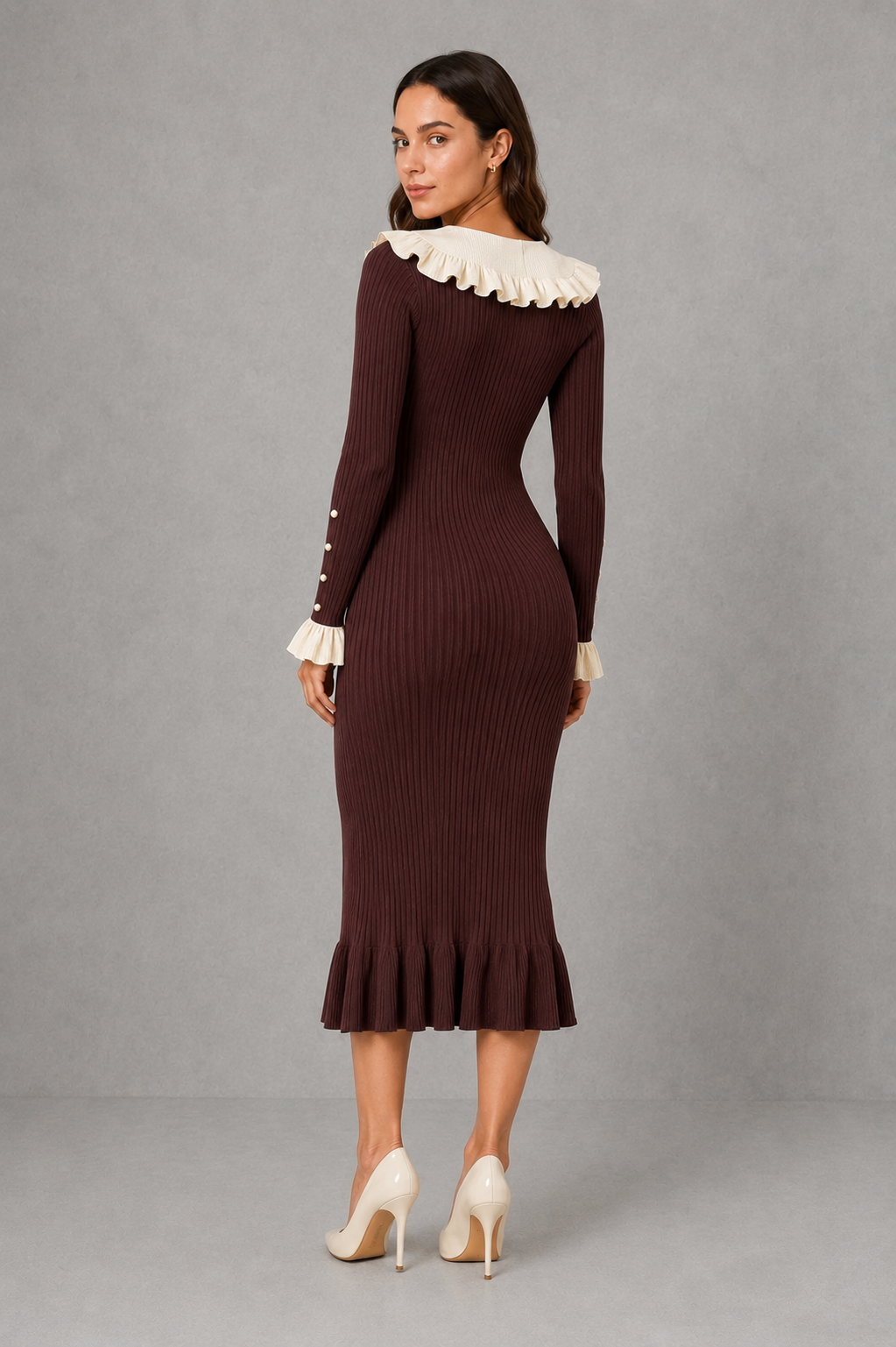 Women’s ribbed knit midi dress with a statement ruffle collar, decorative front buttons, fitted silhouette, long sleeves and flared ruffle cuffs.