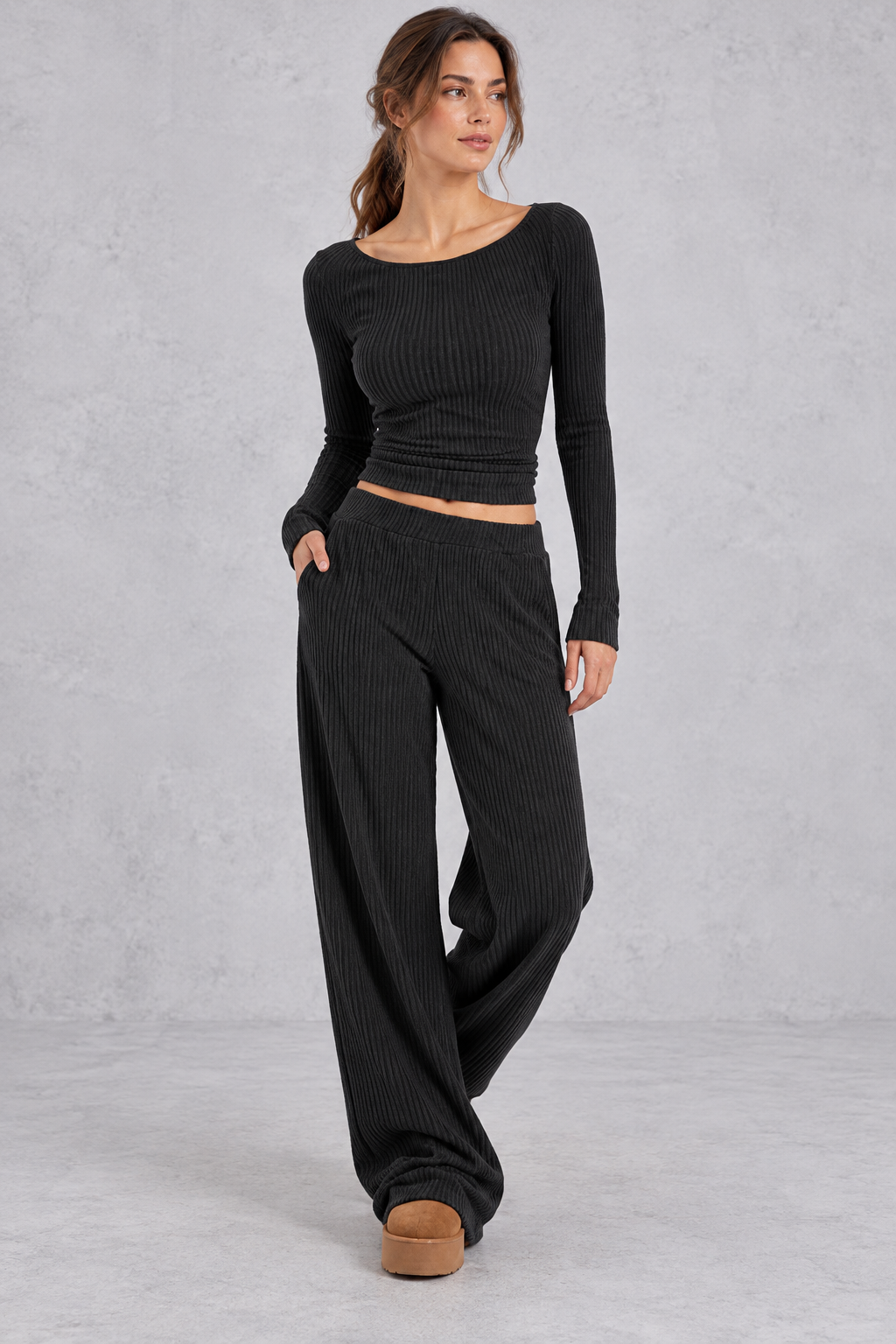 Women's black ribbed knit co-ord set with crop top and wide leg trousers with pockets – front view