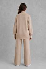 Women’s roll neck knit jumper and wide leg trouser set with an oversized silhouette, dropped shoulders and matching full-length knitted trousers.