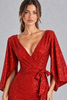 Women’s sequin V-neck evening dress with long raglan sleeves, a high-waisted silhouette, sparkling embellishments and an elegant split detail.