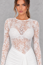 Women’s sheer lace bodycon dress with a round neckline, long sleeves, delicate lace detailing and a sleek fitted silhouette.