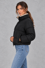 Women’s padded puffer jacket with a soft sherpa-lined high neck, horizontal quilting, full zip front and elasticated cuffs.