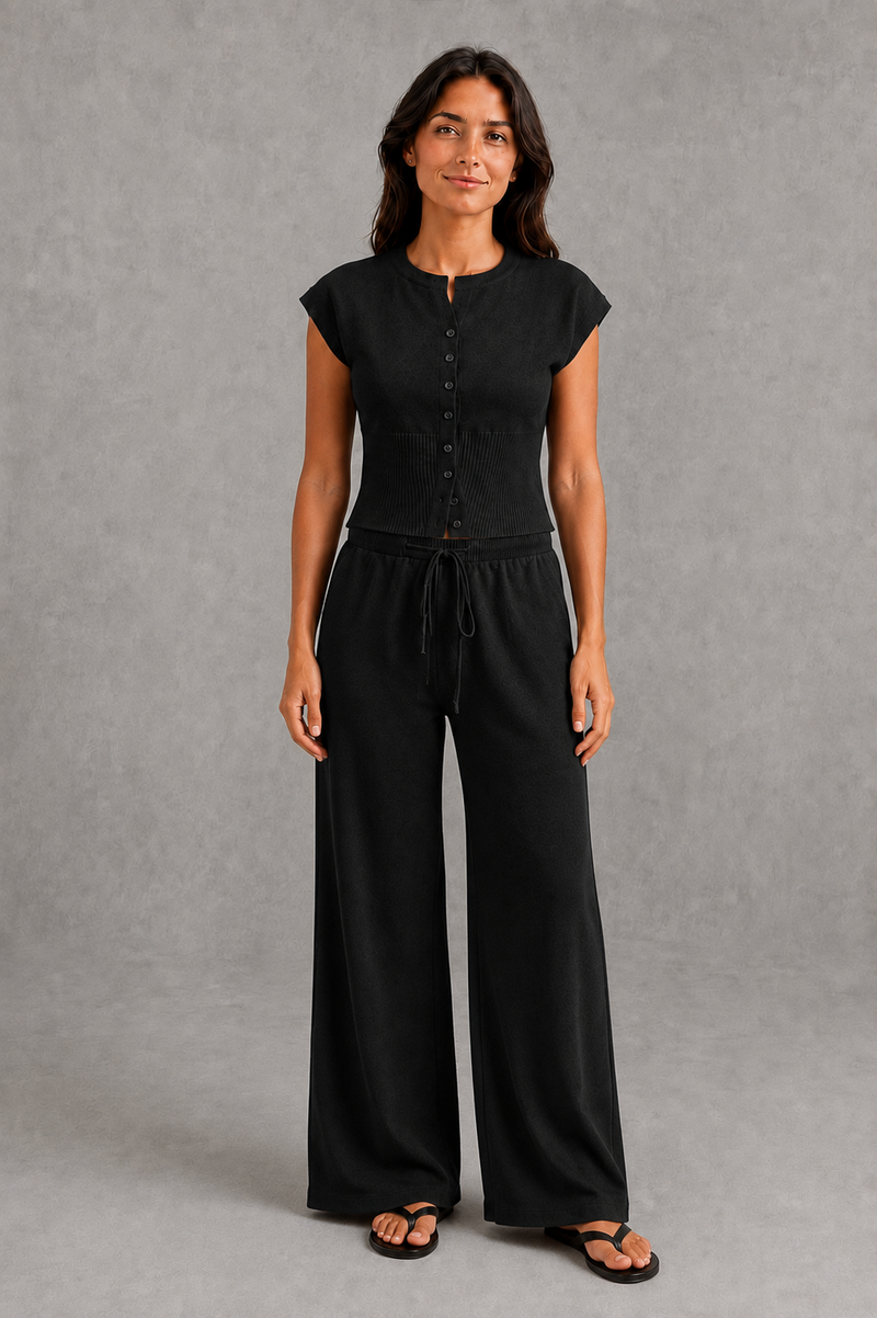 Women’s sleeveless knitted two piece co-ord with button-front fitted top and matching relaxed wide leg drawstring trousers.