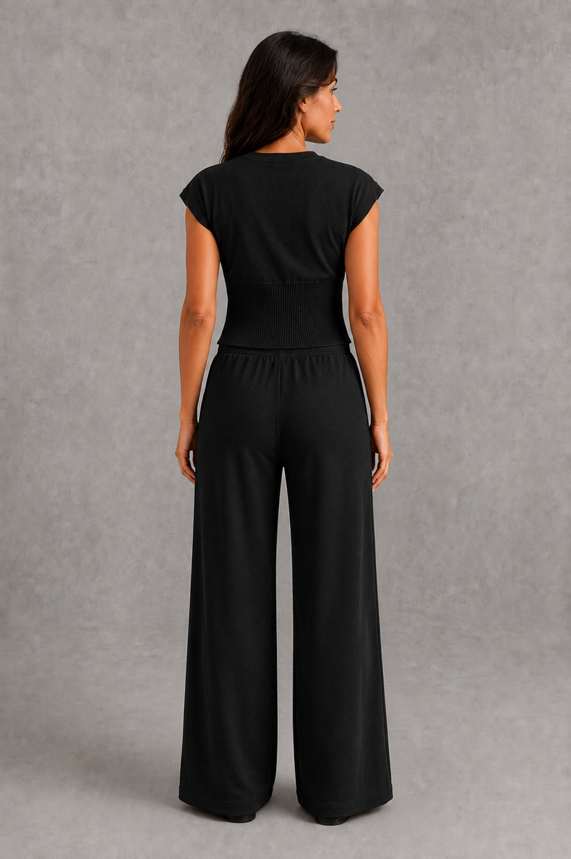 Women’s sleeveless knitted two piece co-ord with button-front fitted top and matching relaxed wide leg drawstring trousers.