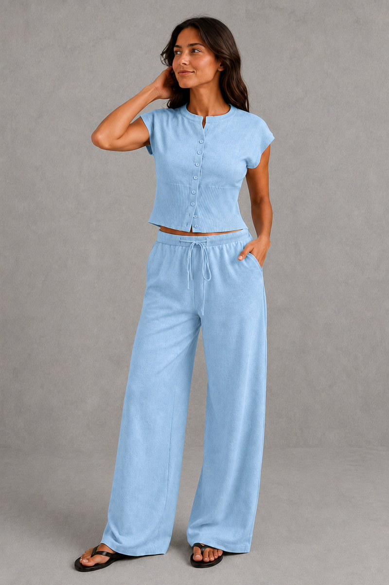 Women’s sleeveless knitted two piece co-ord with button-front fitted top and matching relaxed wide leg drawstring trousers.