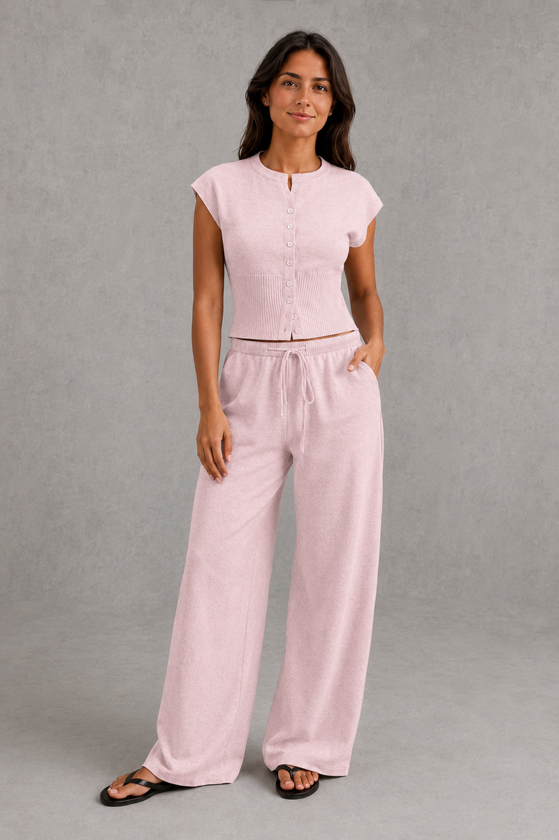 Women’s sleeveless knitted two piece co-ord with button-front fitted top and matching relaxed wide leg drawstring trousers.