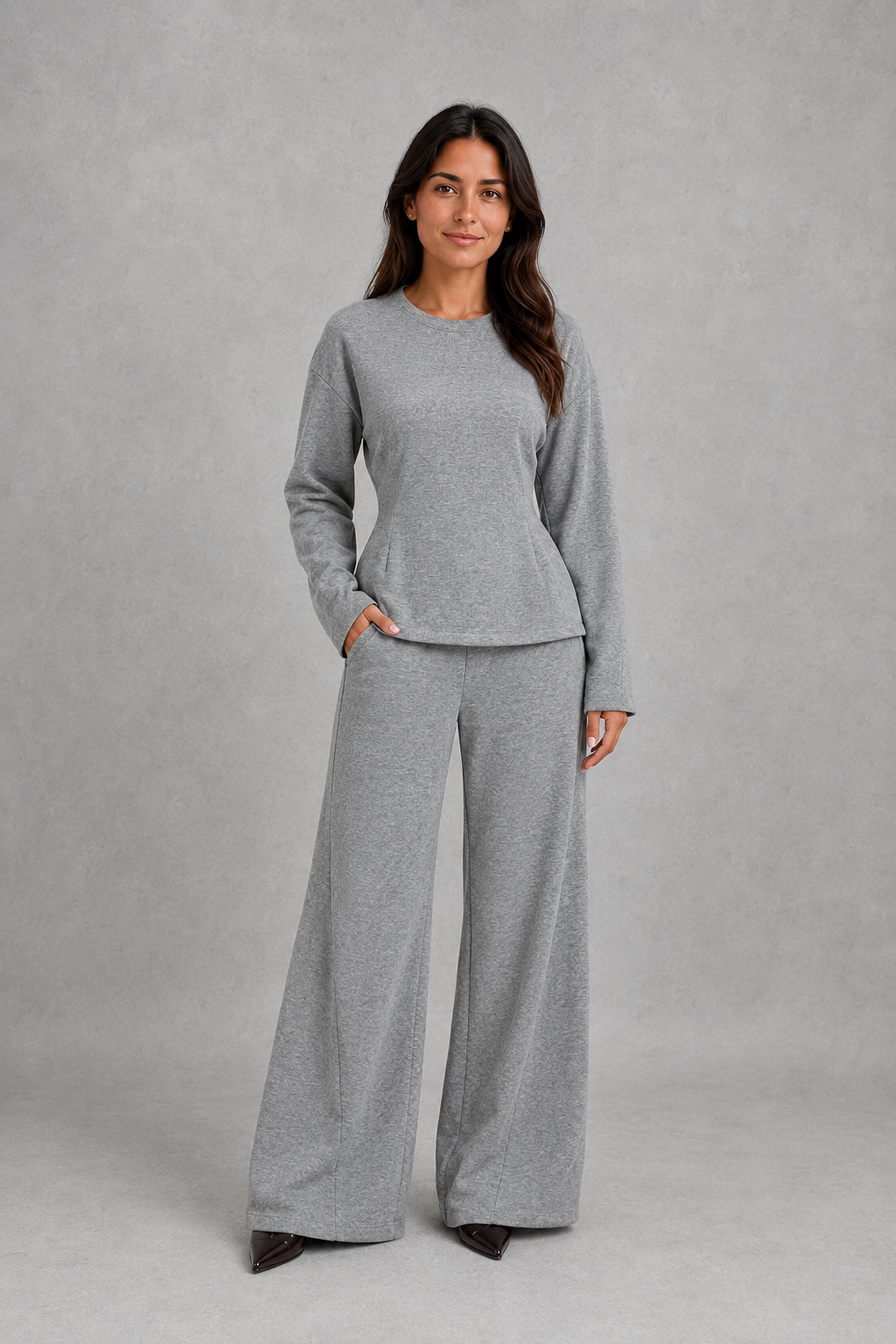 Women’s soft lounge co-ord set featuring a fitted long-sleeve top with a defined waist and coordinating relaxed wide leg trousers with side pockets.