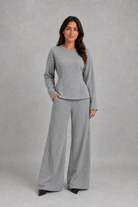 Women’s soft lounge co-ord set featuring a fitted long-sleeve top with a defined waist and coordinating relaxed wide leg trousers with side pockets.