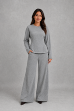 Women’s soft lounge co-ord set featuring a fitted long-sleeve top with a defined waist and coordinating relaxed wide leg trousers with side pockets.