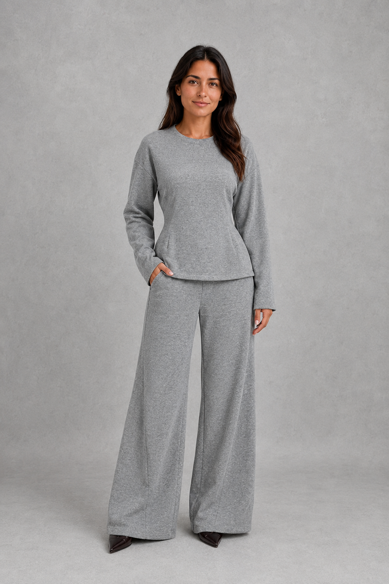 Women’s soft lounge co-ord set featuring a fitted long-sleeve top with a defined waist and coordinating relaxed wide leg trousers with side pockets.