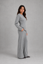 Women’s soft lounge co-ord set featuring a fitted long-sleeve top with a defined waist and coordinating relaxed wide leg trousers with side pockets.