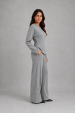Women’s soft lounge co-ord set featuring a fitted long-sleeve top with a defined waist and coordinating relaxed wide leg trousers with side pockets.