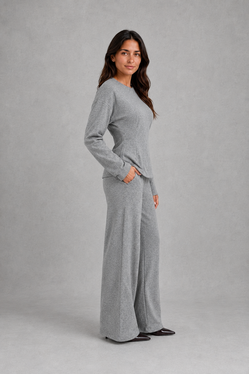 Women’s soft lounge co-ord set featuring a fitted long-sleeve top with a defined waist and coordinating relaxed wide leg trousers with side pockets.