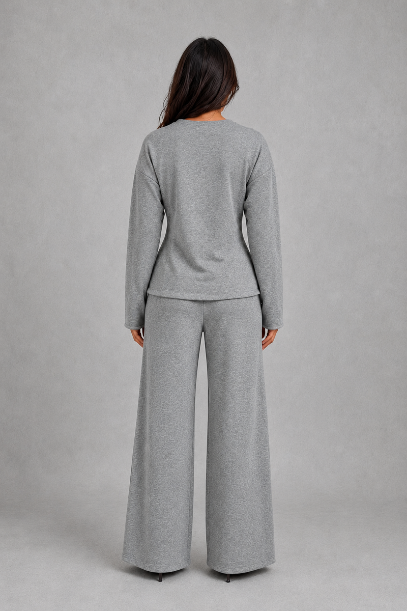 Women’s soft lounge co-ord set featuring a fitted long-sleeve top with a defined waist and coordinating relaxed wide leg trousers with side pockets.