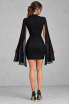Women’s sparkly turtleneck mini party dress with statement lantern sleeves, a shimmering finish and fitted bodycon silhouette.