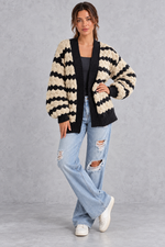 Women's apricot striped chunky knit cardigan with puff sleeves – full-length front view with jeans