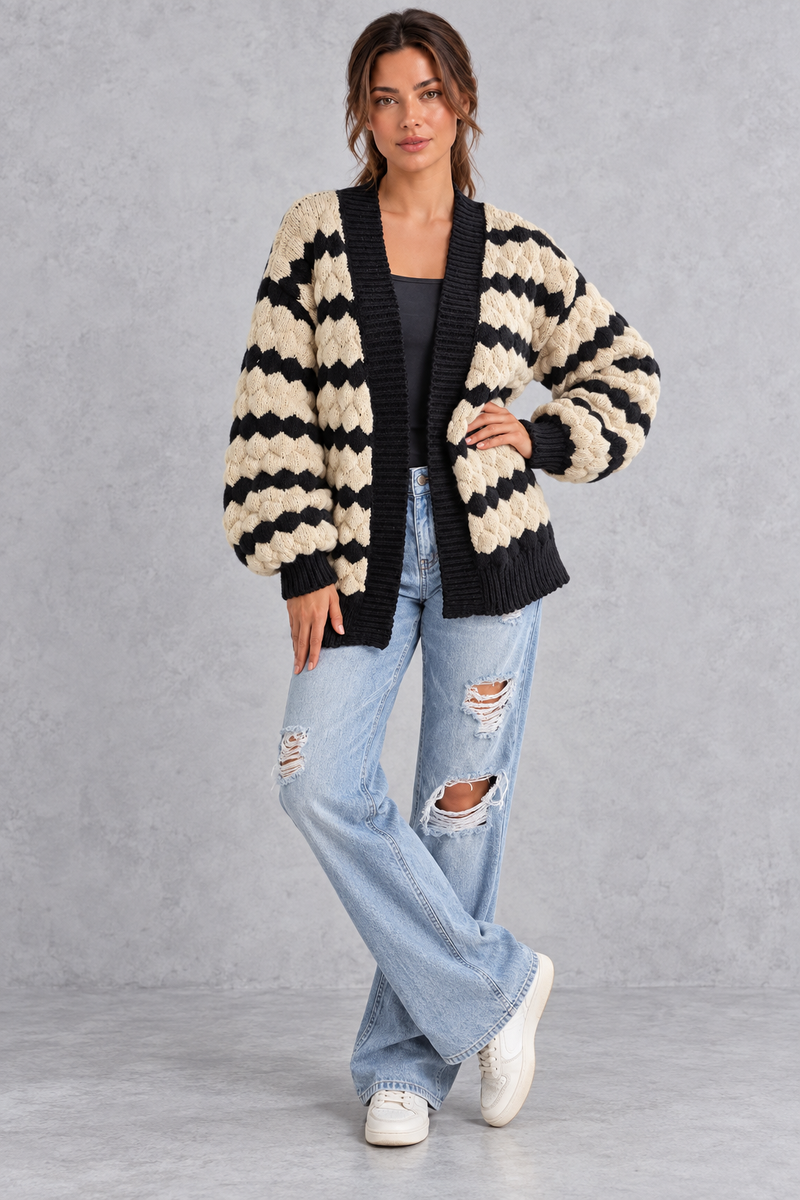 Women's apricot striped chunky knit cardigan with puff sleeves – full-length front view with jeans