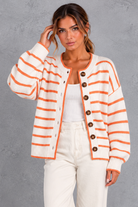 Women's white striped button up knit cardigan with orange stripes – front view