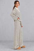 Women's beige striped knit co-ord set with collared V-neck top and wide leg trousers – side view