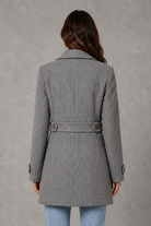 Women’s tailored longline coat with a classic collar, button-front fastening, defined waist, decorative waist tabs and button cuff detailing.