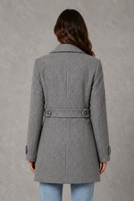 Women’s tailored longline coat with a classic collar, button-front fastening, defined waist, decorative waist tabs and button cuff detailing.