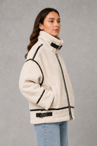 Women’s teddy borg coat with a soft plush texture, relaxed silhouette and practical zip-up front for cosy autumn and winter layering.