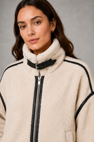 Women’s teddy borg coat with a soft plush texture, relaxed silhouette and practical zip-up front for cosy autumn and winter layering.