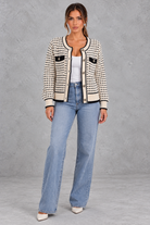 Women’s textured knit cardigan with a round neckline, contrast trims, gold-tone buttons, long sleeves and structured chest pockets.