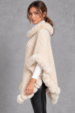Women's textured knitted poncho in Cream – side view
