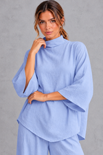 Women's blue turtleneck blouse – close-up of high neck and three-quarter sleeves